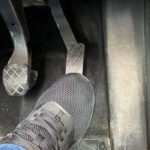 what causes a stiff gas pedal